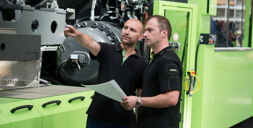 Picture shows service technicians at ENGEL